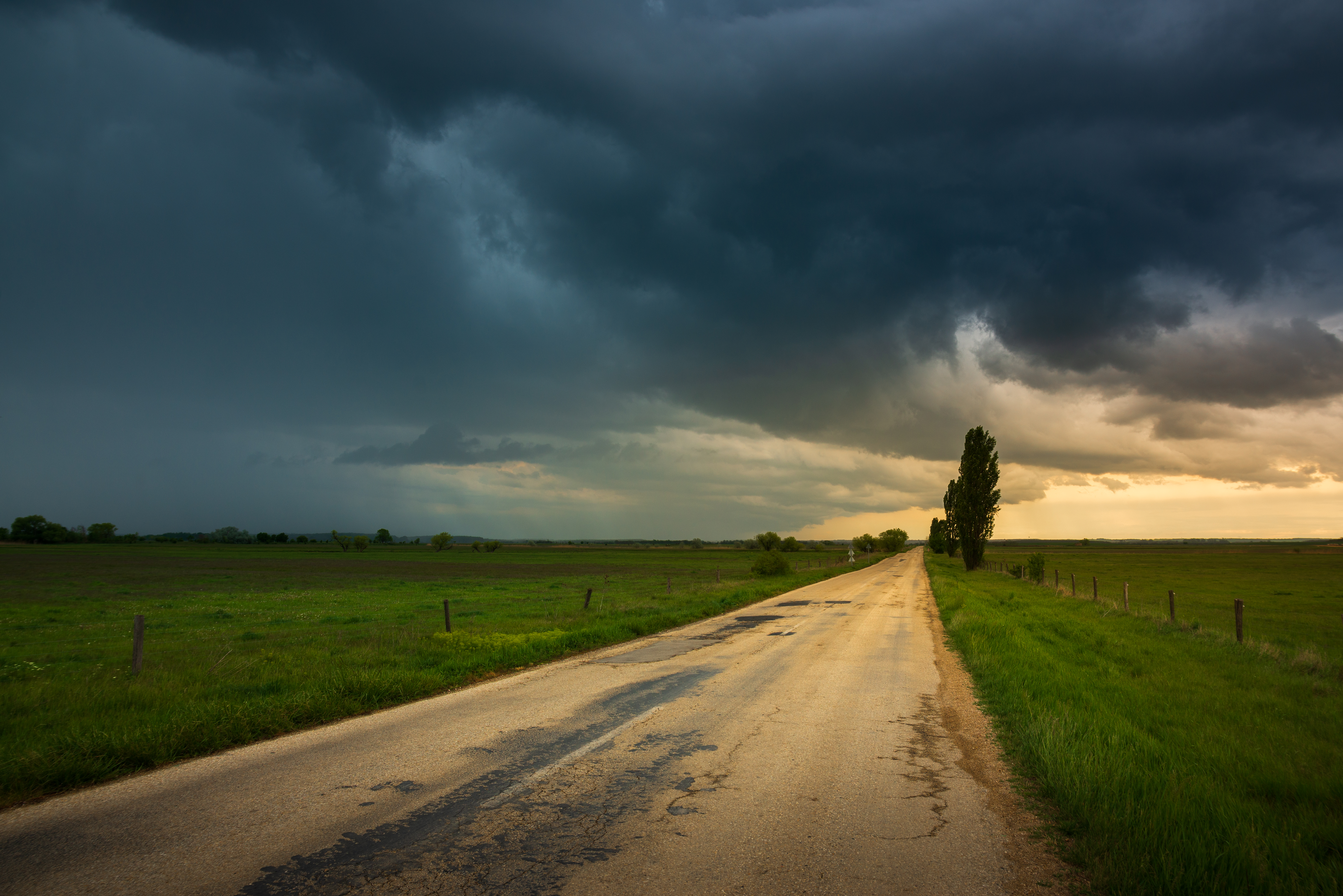Dark storm clouds over the country road , moody dark sky